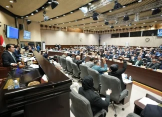 A representative shows the laws prepared for voting during the upcoming sessions.