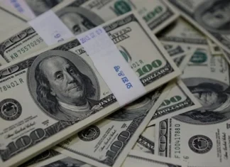 The dollar is holding steady near a one-week high ahead of the Federal Reserve chairman's speech in Jackson Hole.
