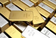 Gold holds near record highs as the world awaits US jobs data.